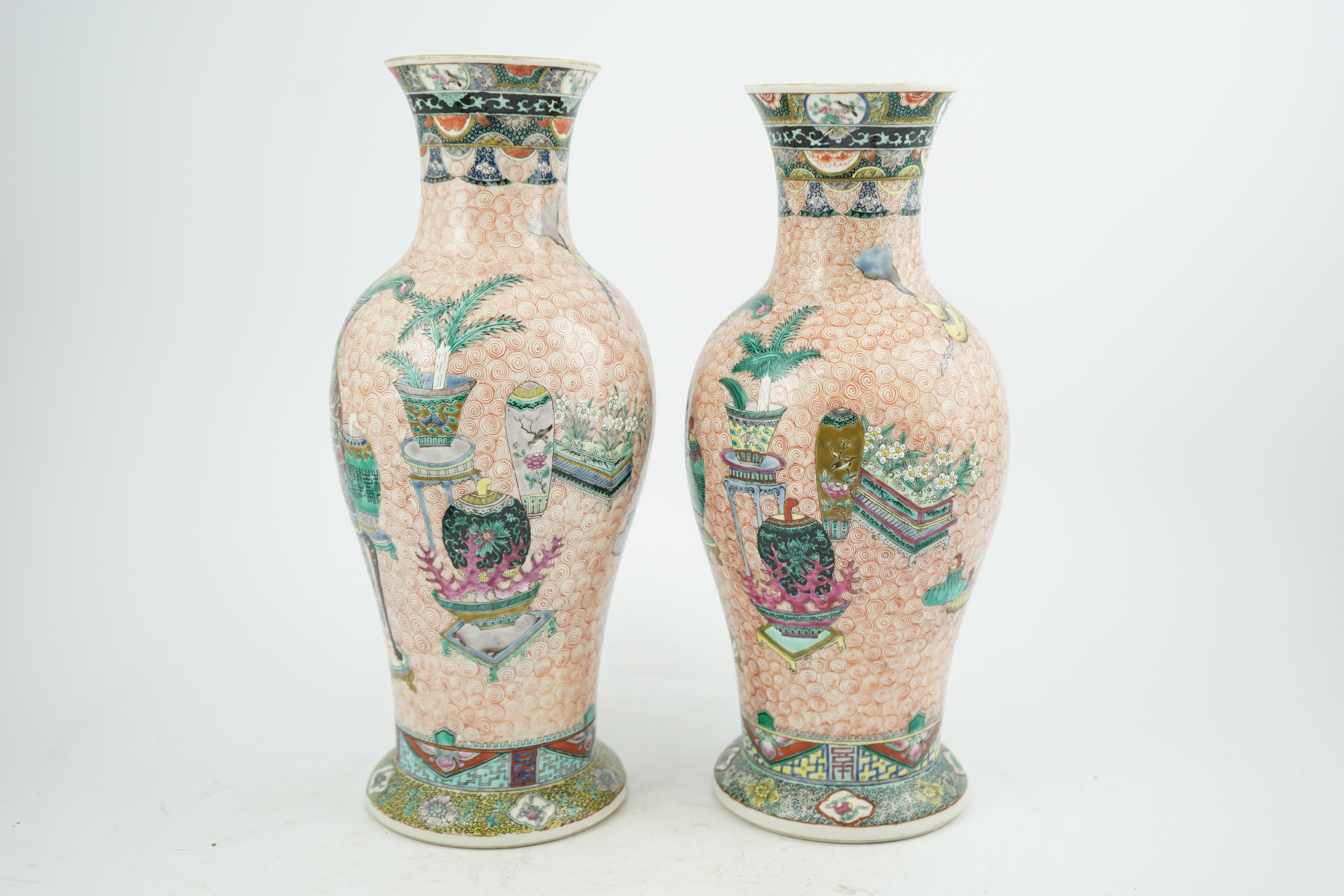 A near pair of Chinese famille rose ‘Hundred Antiques’ baluster vases, Kangxi mark, early 20th century